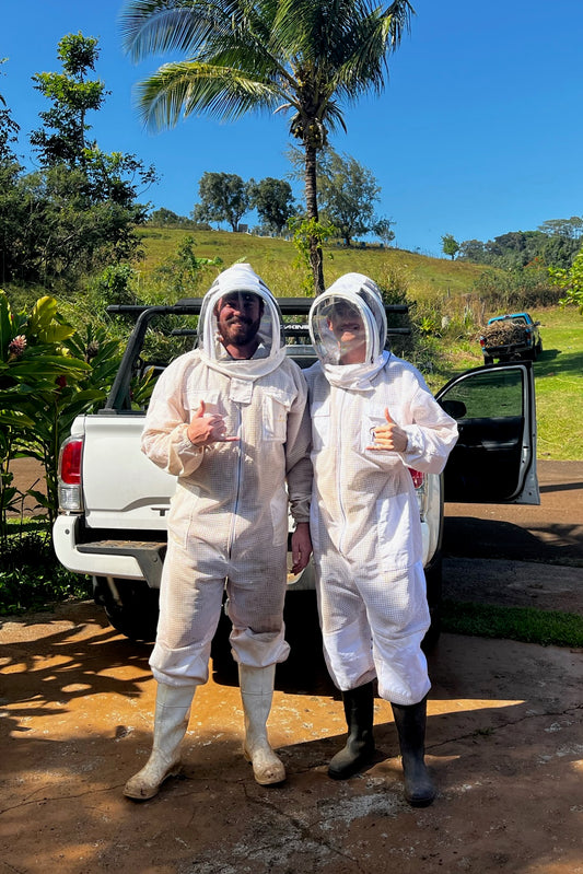 Two beekeepers in bee suits